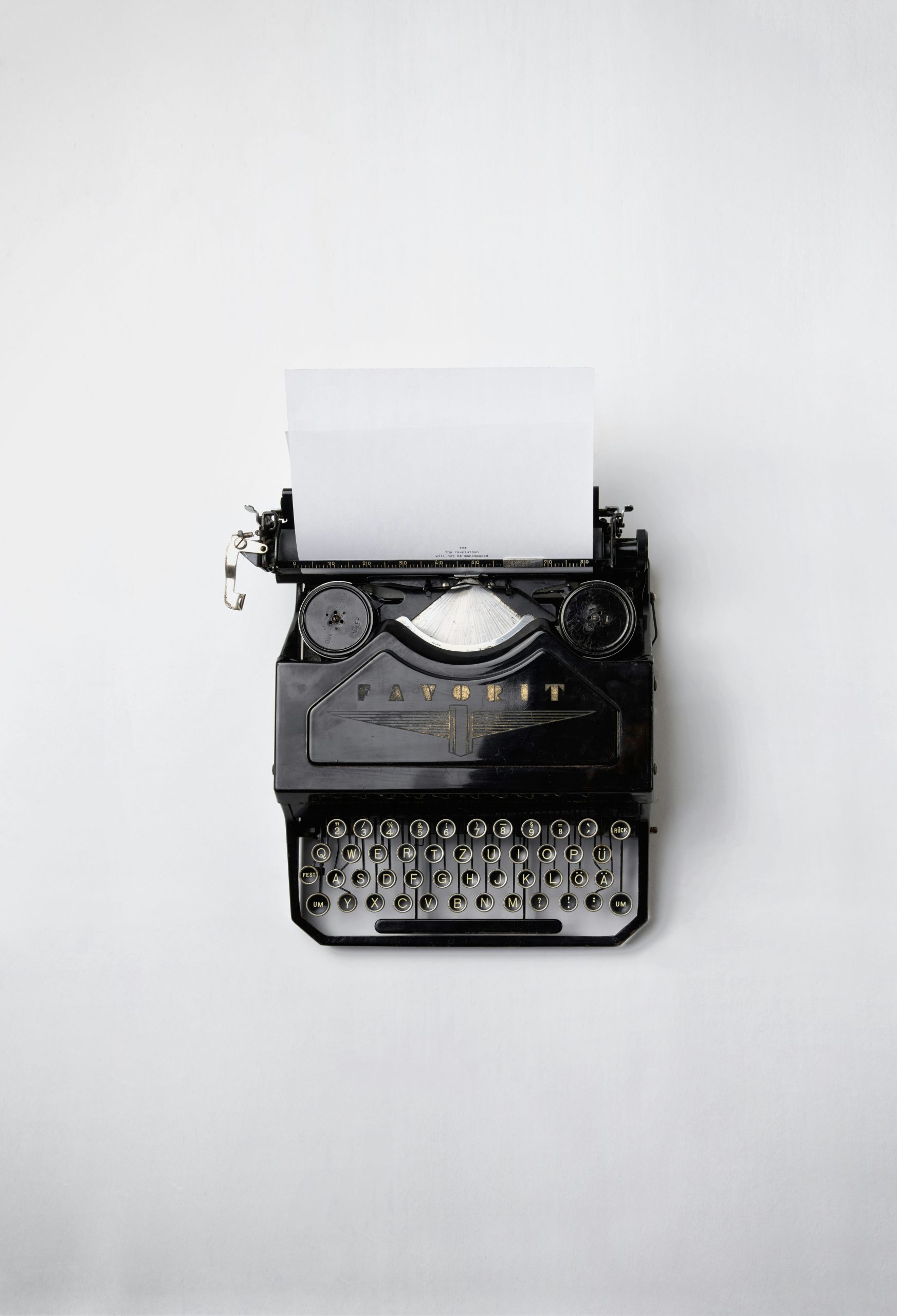 typewriter with a sheet of white paper inserted