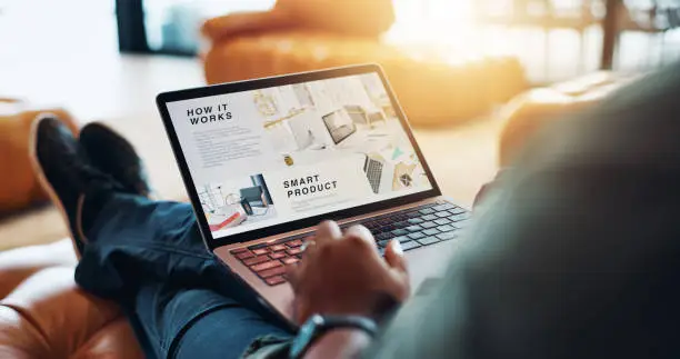 Person working with a laptop on their lap